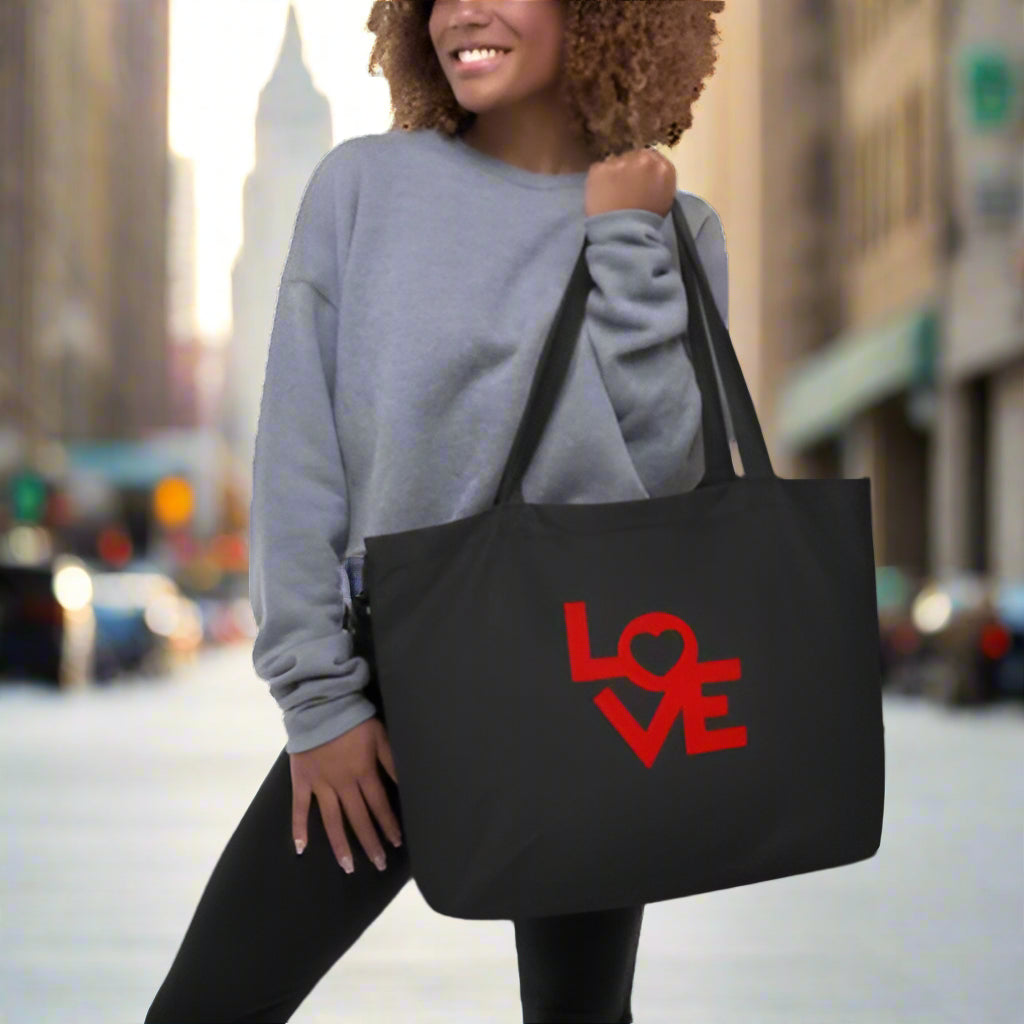 woman holding black eco tote with word Love
