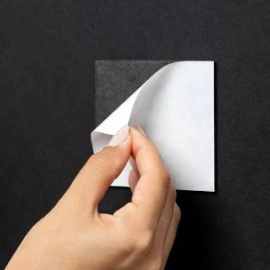 woman pulls magnet off back of wall art